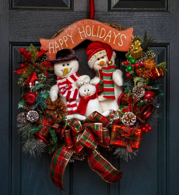 The wreath on the front door is the first item ever hung for the holiday lights display in the ...