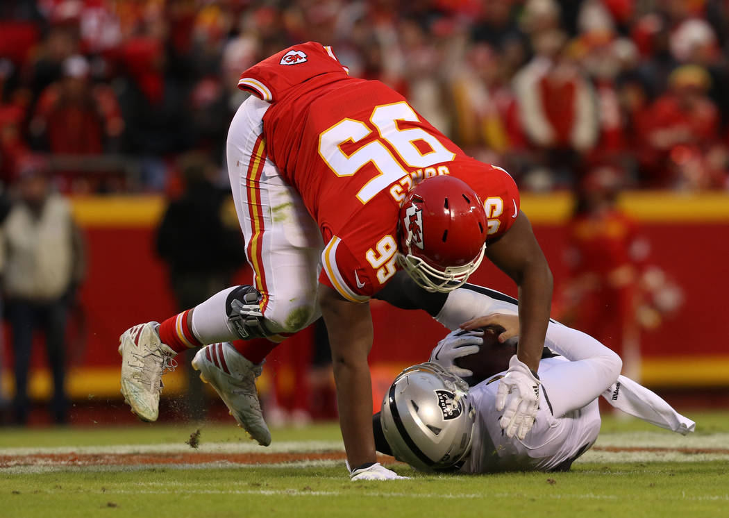 Kansas City Chiefs defensive end Chris Jones (95) sacks Oakland Raiders quarterback Derek Carr ...