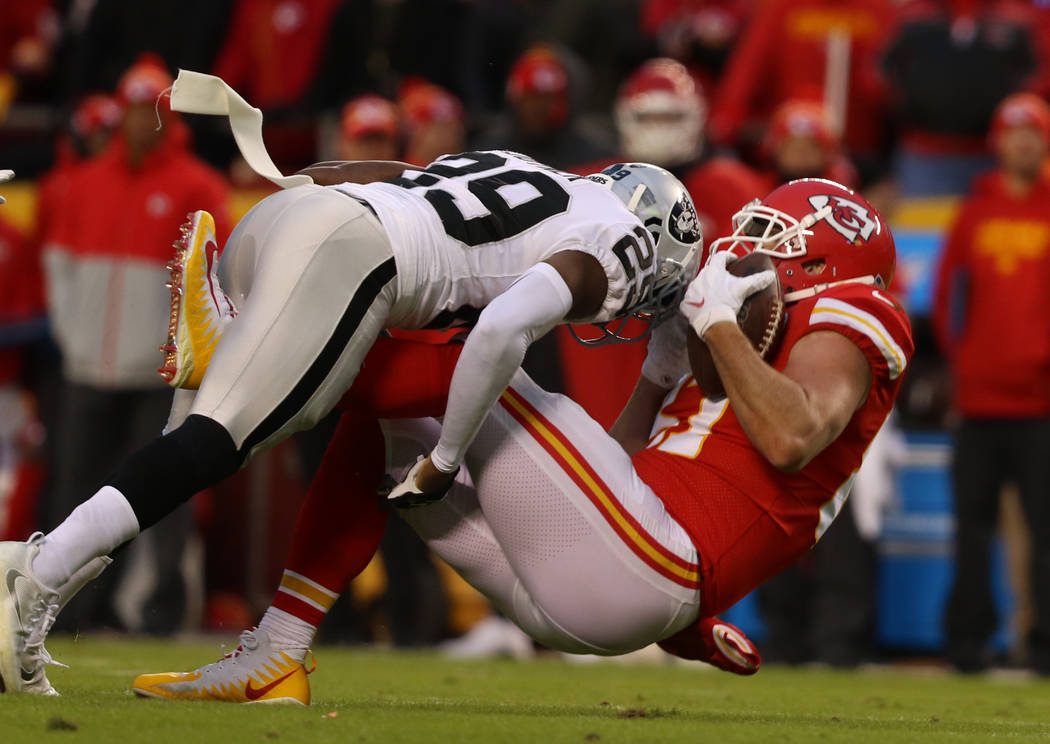 Kansas City Chiefs tight end Travis Kelce (87) is tackled by Oakland Raiders free safety Lamarc ...