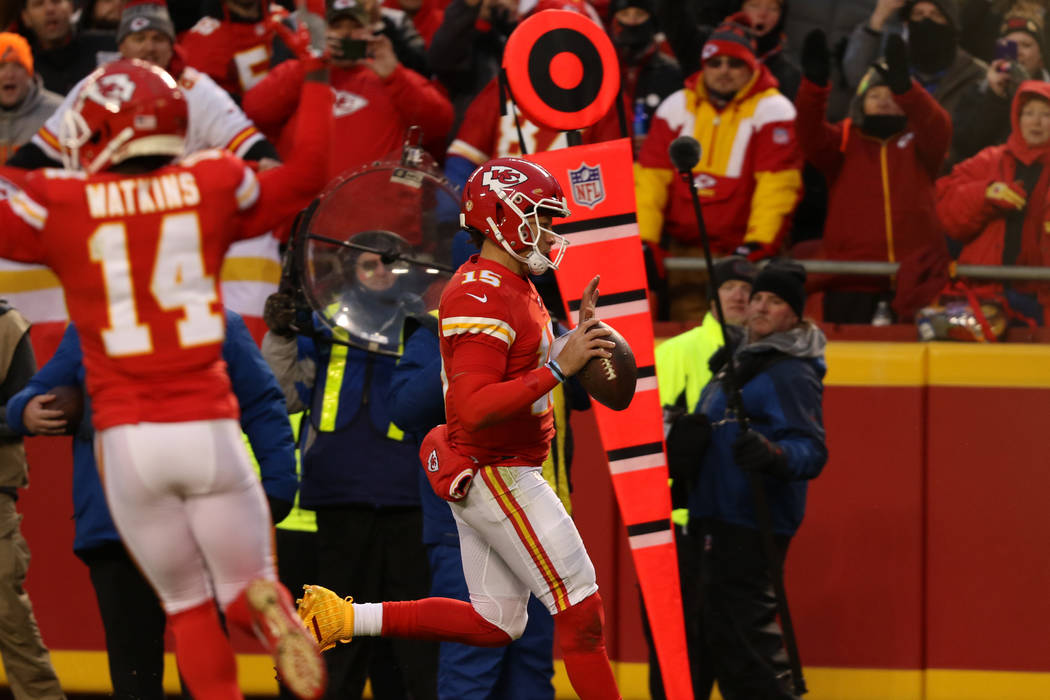 Kansas City Chiefs quarterback Patrick Mahomes (15) rushes into the end zone and scores a touch ...