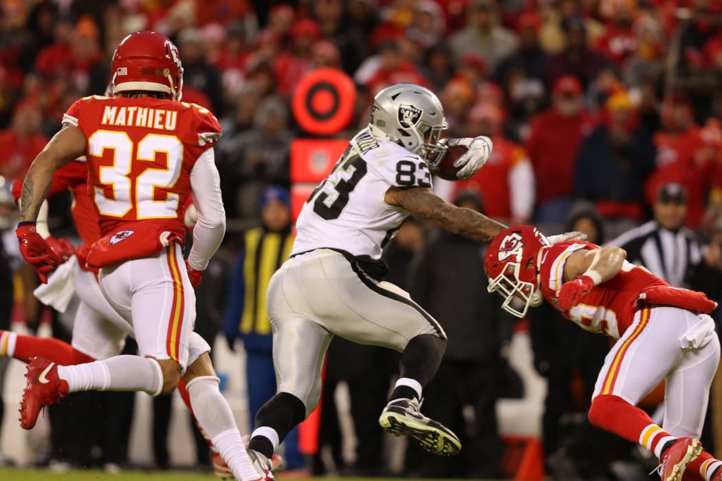 Oakland Raiders tight end Darren Waller (83) stiff arms Kansas City Chiefs cornerback Kendall F ...