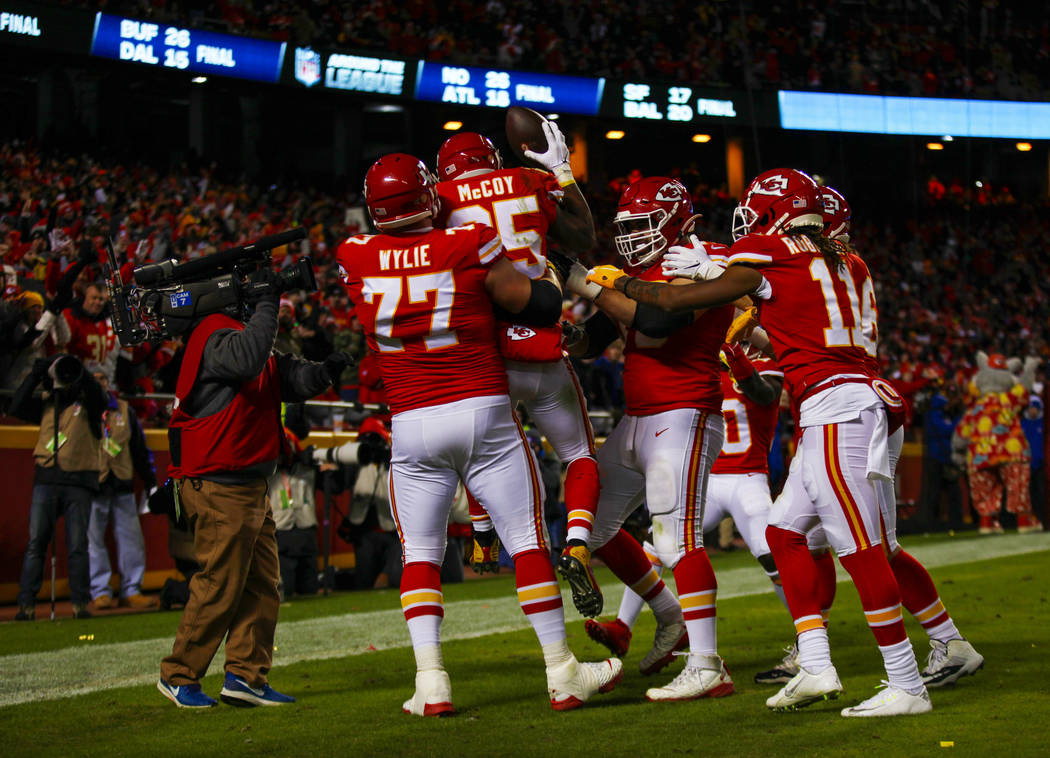Kansas City Chiefs running back LeSean McCoy (25) is lifted up by offensive guard Andrew Wylie ...