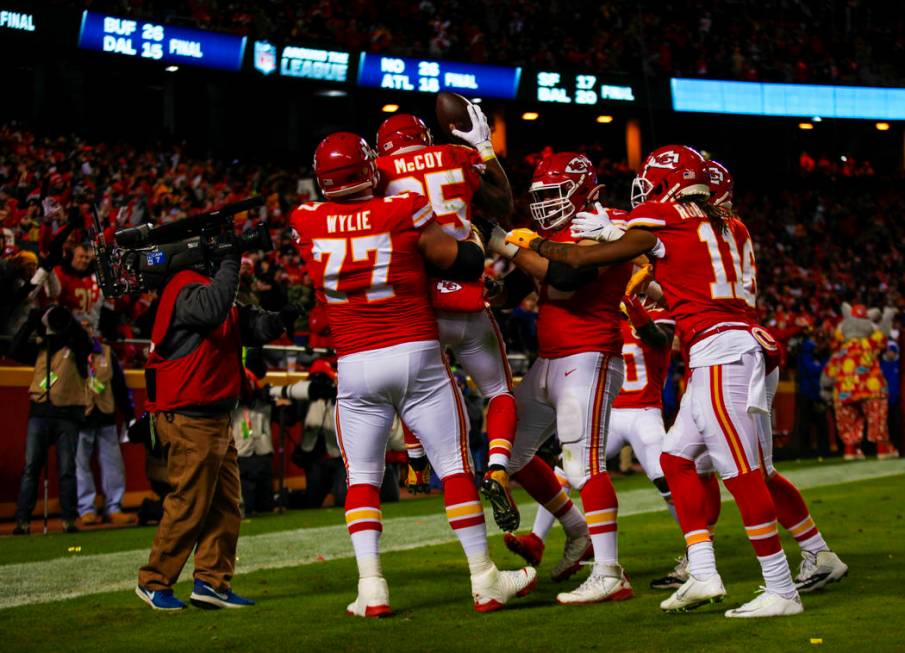 Kansas City Chiefs running back LeSean McCoy (25) is lifted up by offensive guard Andrew Wylie ...