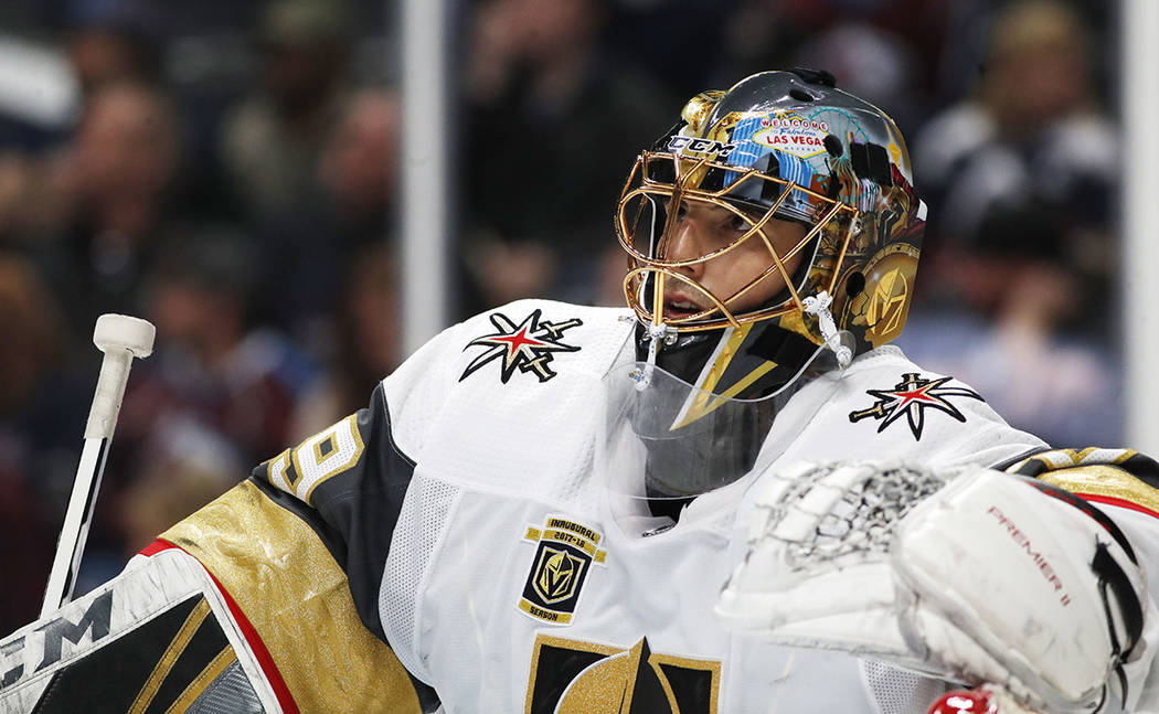 Vegas Golden Knights goaltender Marc-Andre Fleury leans on the top of the net during a time out ...