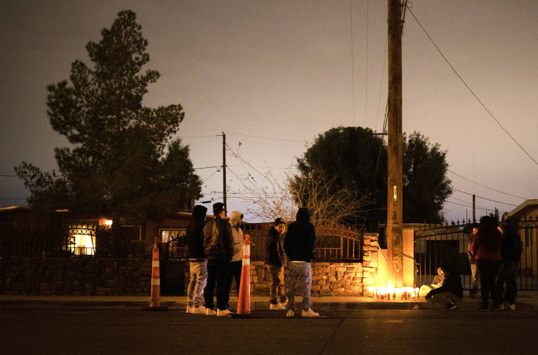 People gather to mourn a 17-year-old boy who was shot and killed near the 2600 block of Ferguso ...