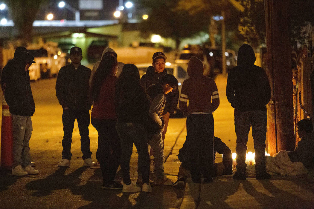 People gather to mourn a 17-year-old boy who was shot and killed near the 2600 block of Ferguso ...