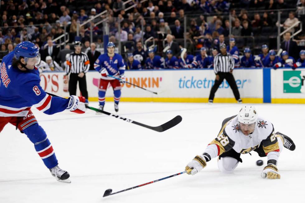 Vegas Golden Knights left wing William Carrier (28) blocks a shot by New York Rangers defensema ...