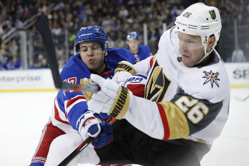 New York Rangers defenseman Tony DeAngelo (77) tries to stop a pass by Vegas Golden Knights cen ...