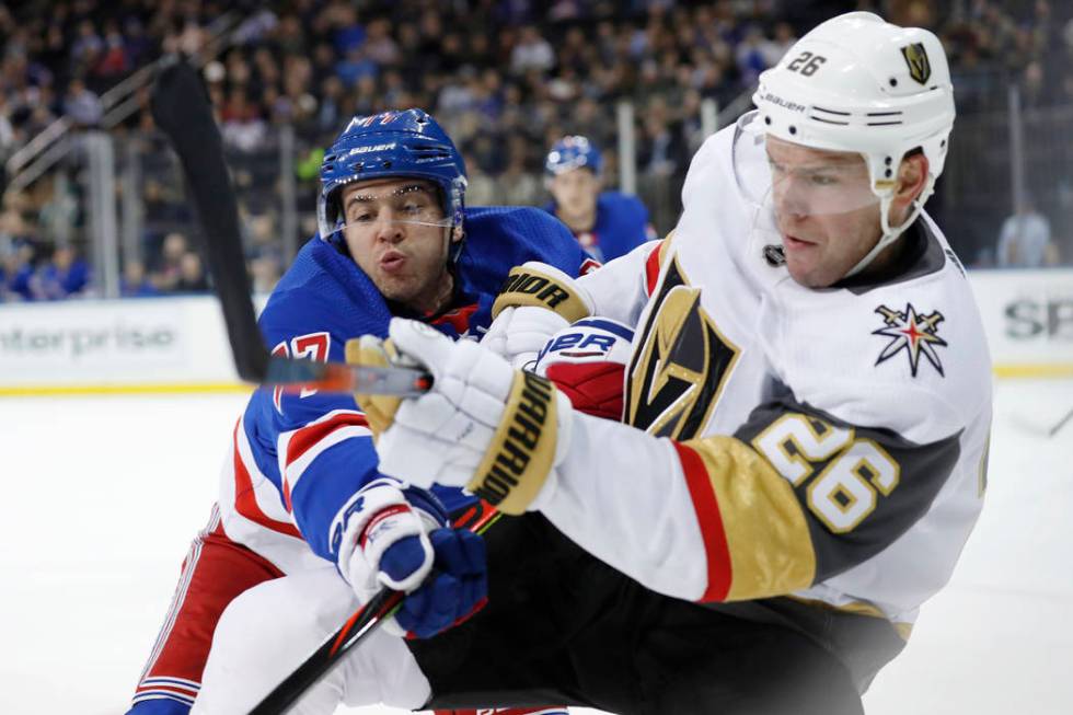 New York Rangers defenseman Tony DeAngelo (77) tries to stop a pass by Vegas Golden Knights cen ...