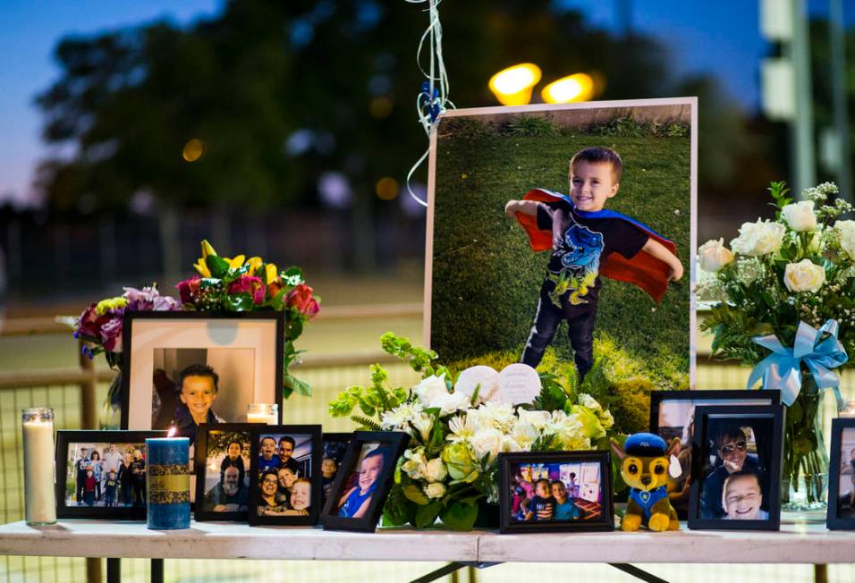 Photos of Gavin Murray Palmer, who was lost in a house fire, during a candlelight vigil in his ...