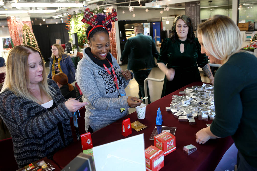 Zappos Fungineers Audrea Hooper, right, and Roni Roberts, second from right, help Nicole Morgan ...