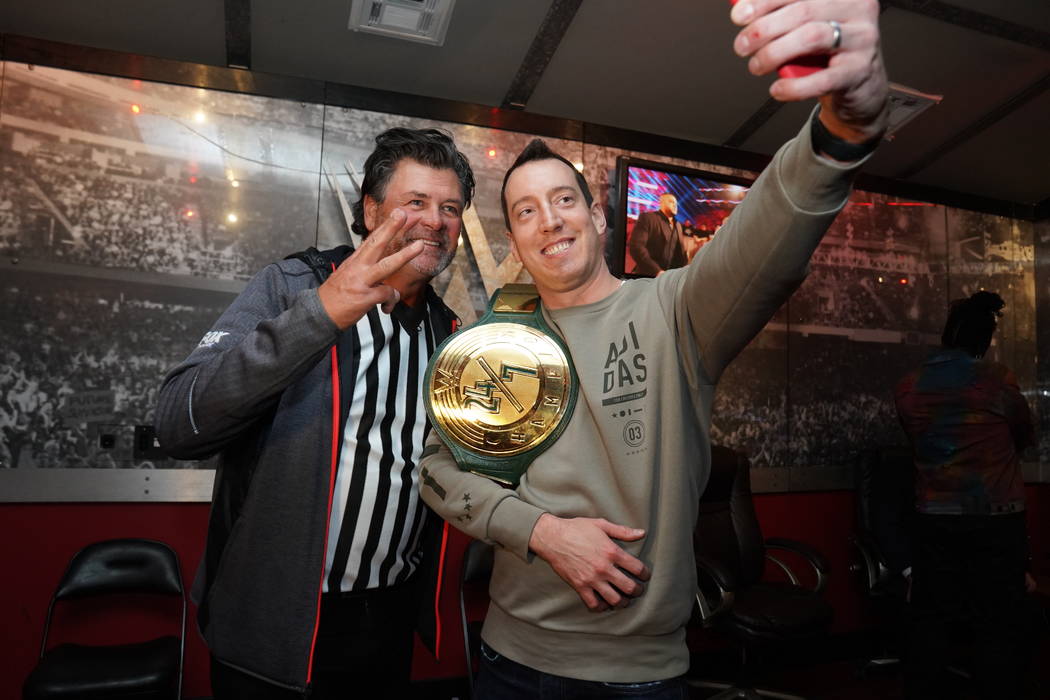 NASCAR Monster Cup champion Kyle Busch, right, with famed driver Michael Waltrip, celebrates ba ...