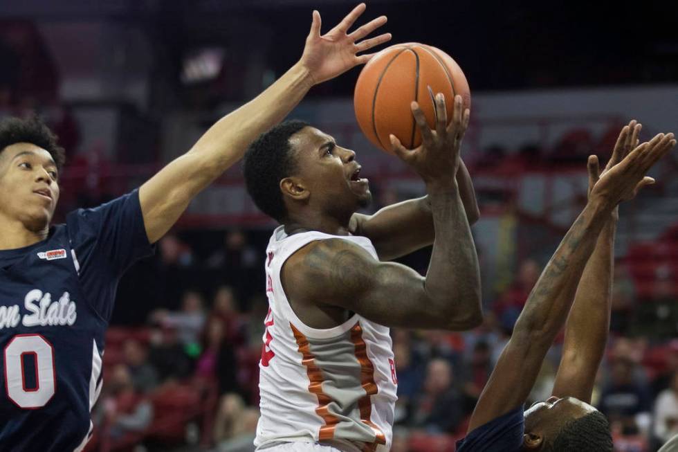 UNLV Rebels guard Amauri Hardy (3) drives past Jackson State Tigers guard Venjie Wallis (0) and ...