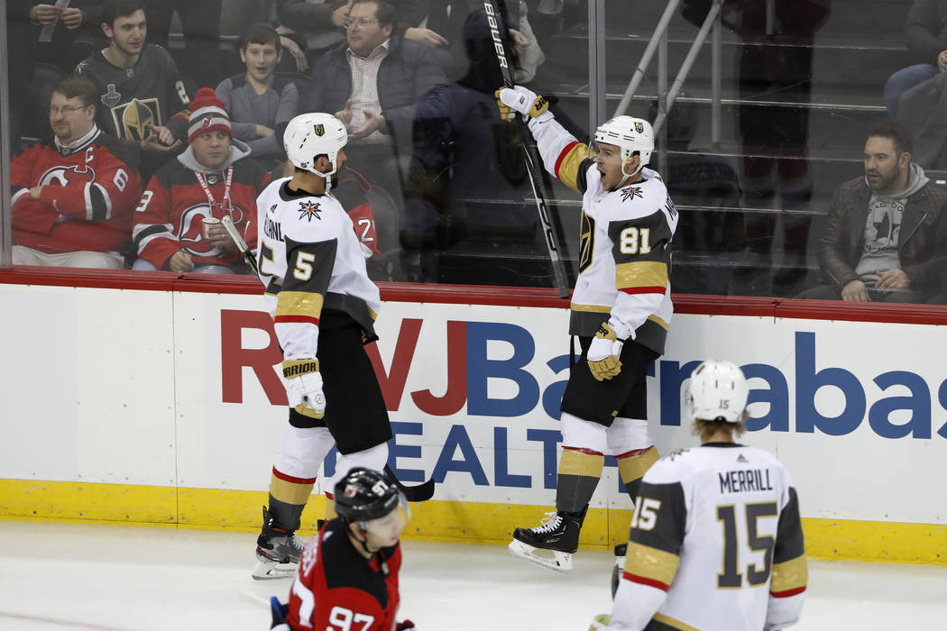 Vegas Golden Knights center Jonathan Marchessault (81) reacts toward defenseman Deryk Engelland ...