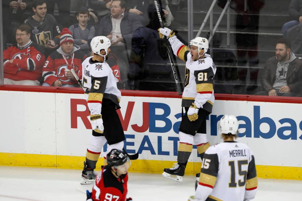 Vegas Golden Knights center Jonathan Marchessault (81) reacts toward defenseman Deryk Engelland ...