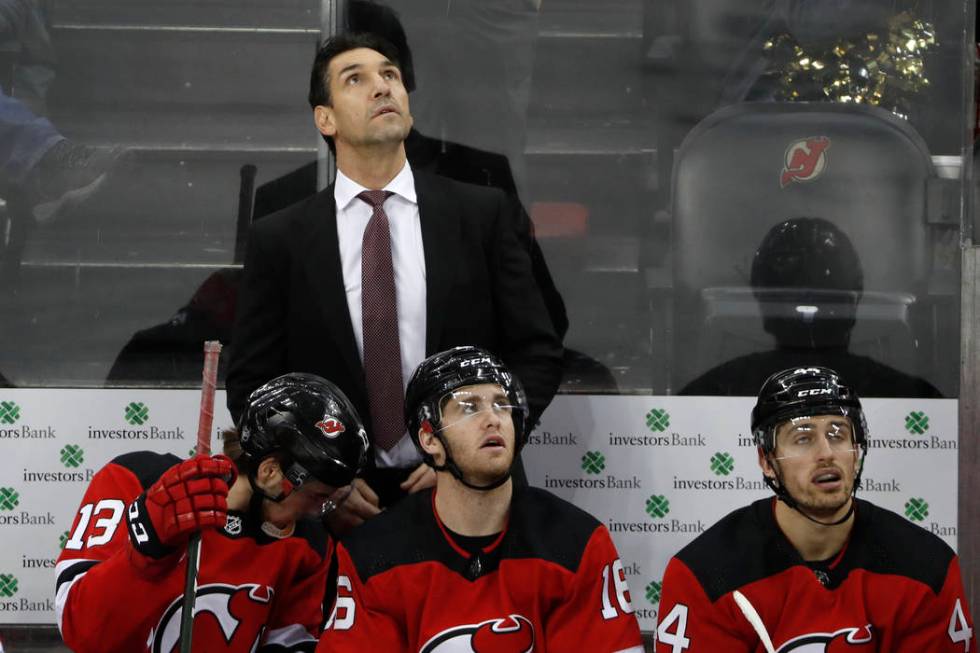 New Jersey Devils interim coach Alain Nasreddine watches a video replay of the third goal score ...