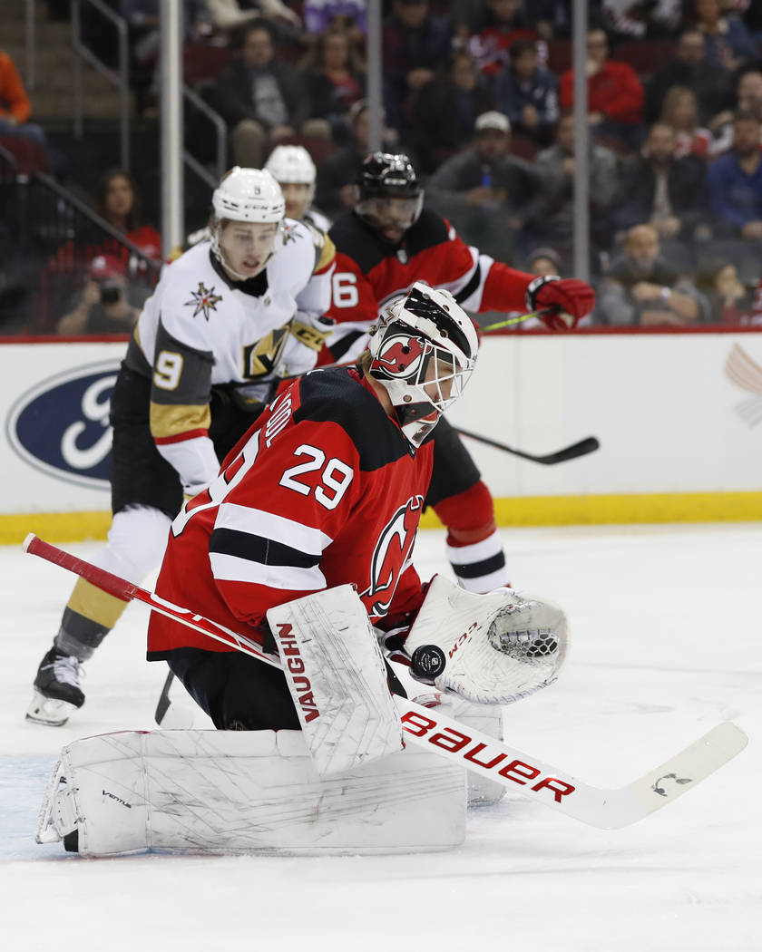 New Jersey Devils goaltender Mackenzie Blackwood (29) bobbles the puck as he makes a save with ...