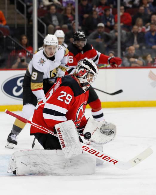 New Jersey Devils goaltender Mackenzie Blackwood (29) bobbles the puck as he makes a save with ...