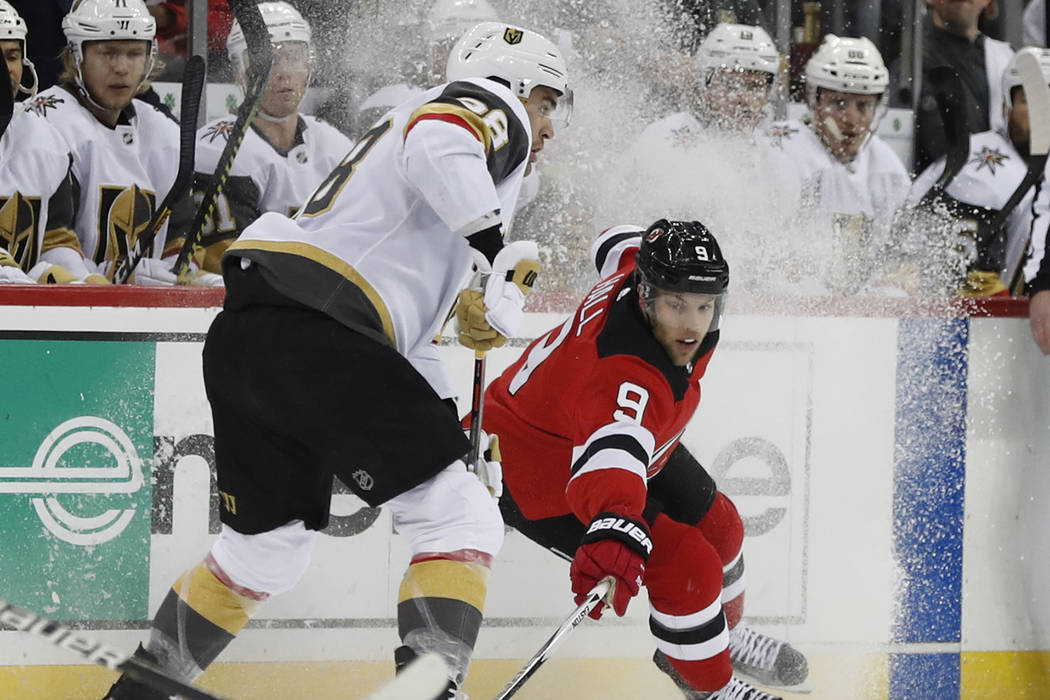 New Jersey Devils left wing Taylor Hall (9) tries to corral the puck away from Vegas Golden Kni ...