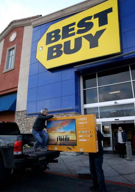 Deric Schare of Las Vegas loads a 70-inch TV with the help of employee Patrick Granado at Best ...