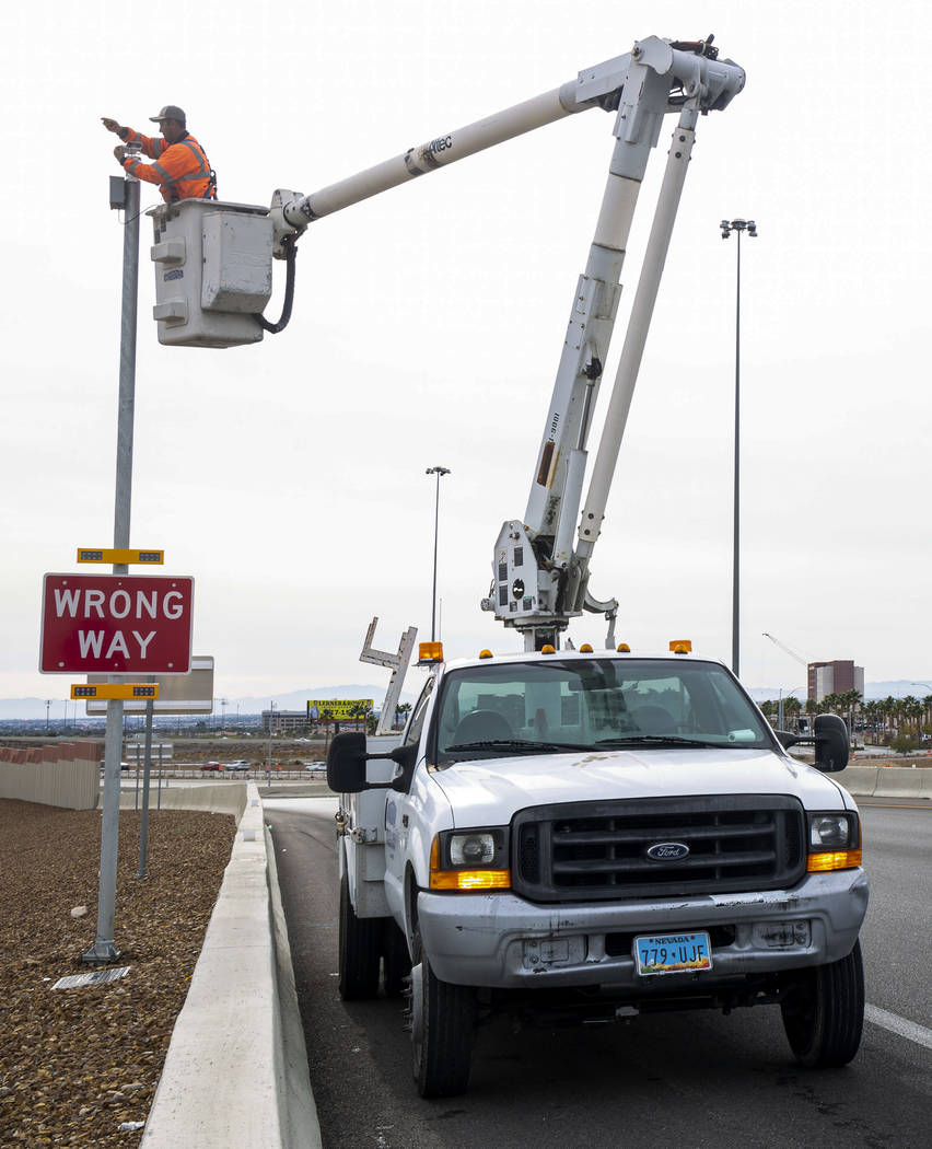 Electrician Sam Martinez with Lam Contracting installs cameras for the Nevada Department of Tra ...
