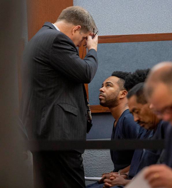 Defense attorney Craig Mueller, left, speaks to Nathaniel Postelle during a hearing at the Regi ...