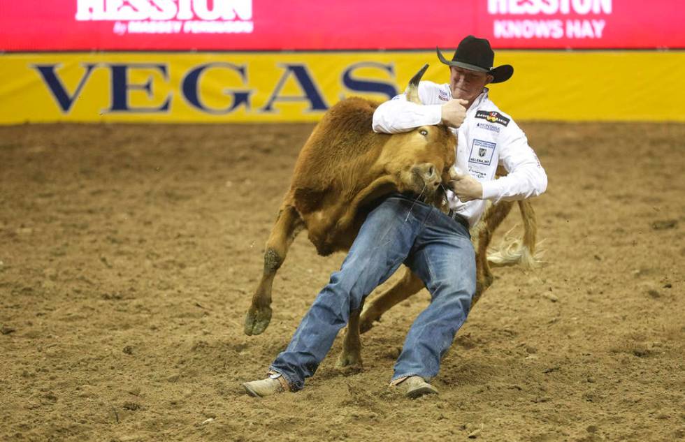 Ty Erickson of Helena, Mont. (59) competes in the steer wrestling event during the ninth go-rou ...