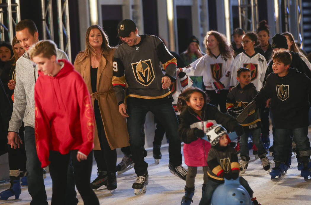 Golden Knights' Alex Tuch, center left, skates with hockey fans during the "Night With the ...