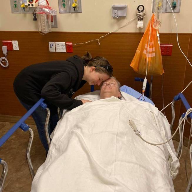 Lisa Light, left, leans over her father, Nevada State Sen. Keith Pickard, after Pickard was res ...