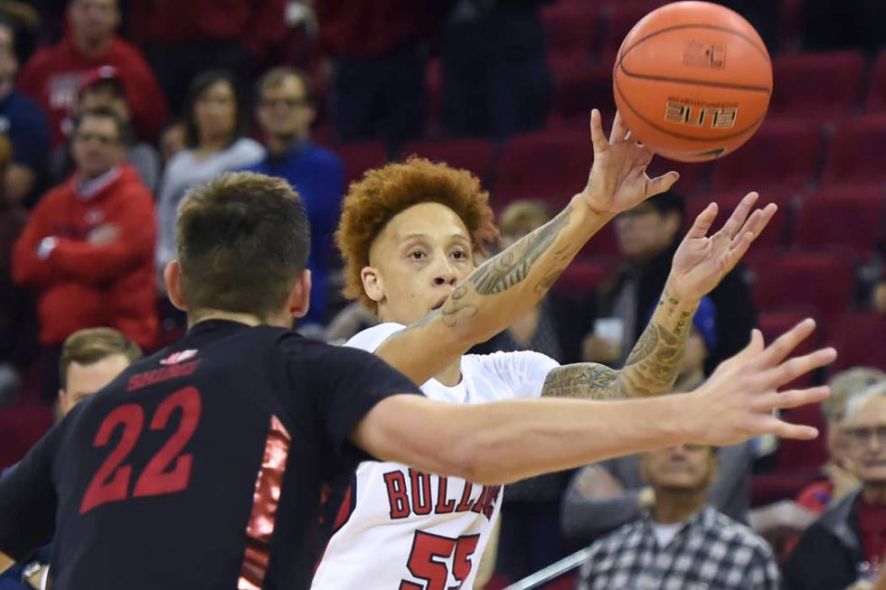 Fresno State's Noah Blackwell, right, passes the ball with UNLV's Vitaliy Shibel, left, defendi ...