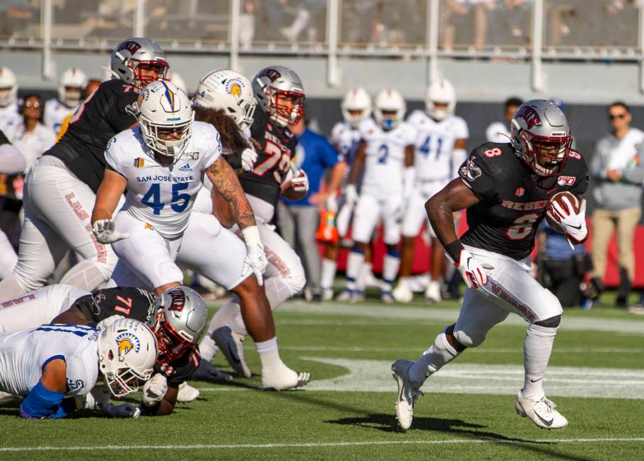 UNLV Rebels running back Charles Williams (8, right) breaks free of the San Jose State Spartans ...