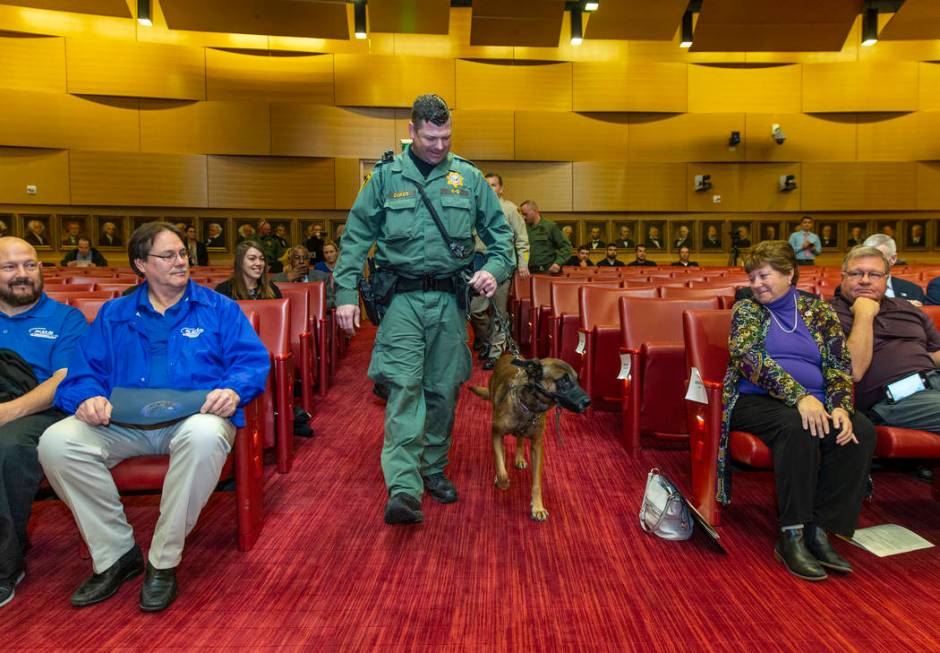 Las Vegas police K-9 officer Jason Dukes brings Hunter down to aisle to be recognized by the La ...