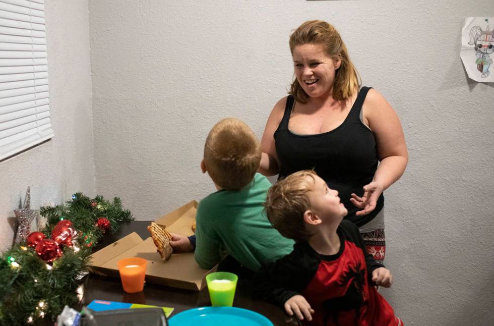 Joan Williams laughs with her sons Chase Huebner, 6, left, and John Huebner, 2, right, as they ...