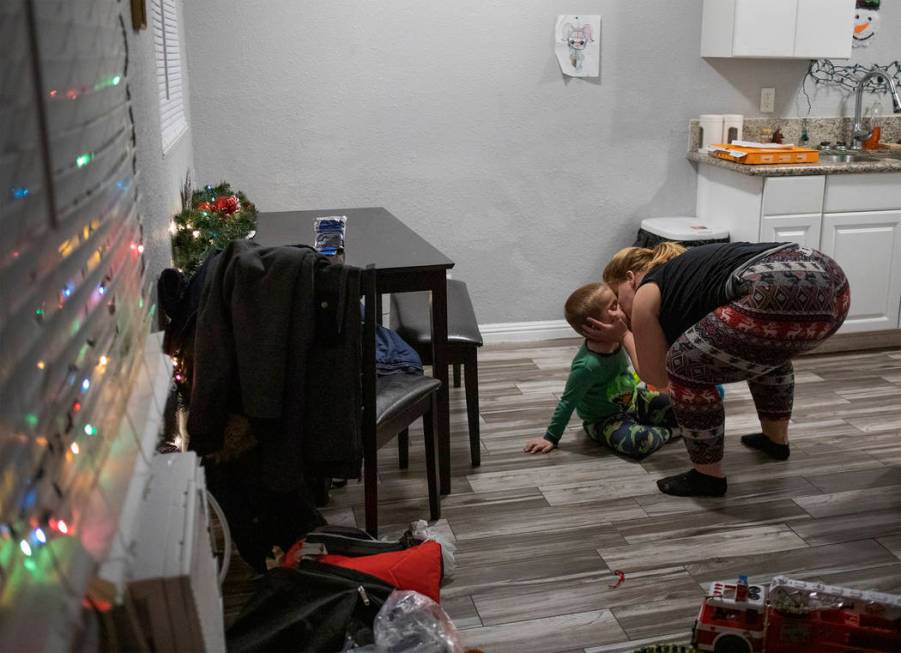 Joan Williams kisses her son, Chase Huebner, 6, in their new one-bedroom apartment on Saturday, ...