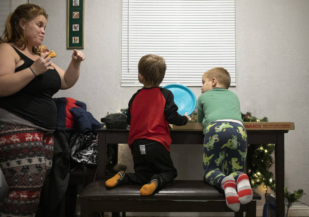Joan Wiliiams, left, chats with her sons John Huebner, 2, center, and Chase Huebner, 6, right, ...