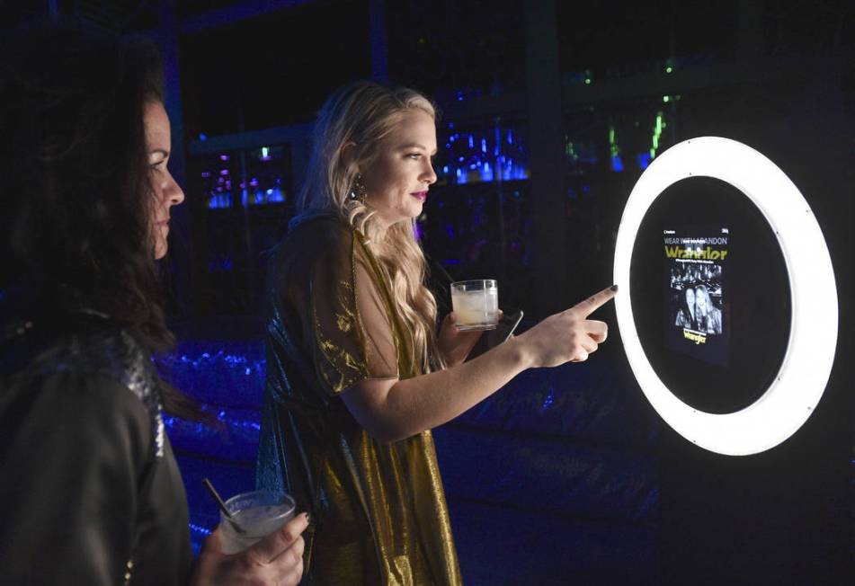 Attendees use the selfie station during the WNFR Party With Abandon at the Ling Ling Club in Ha ...