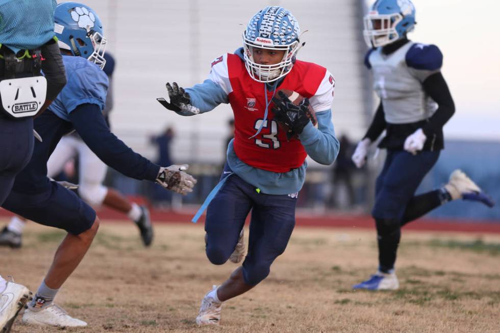 Centennial's Gerick Robinson runs the ball during a team practice at Centennial High School in ...