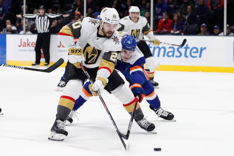 Vegas Golden Knights center Chandler Stephenson (20) tries to steer the puck away from New York ...