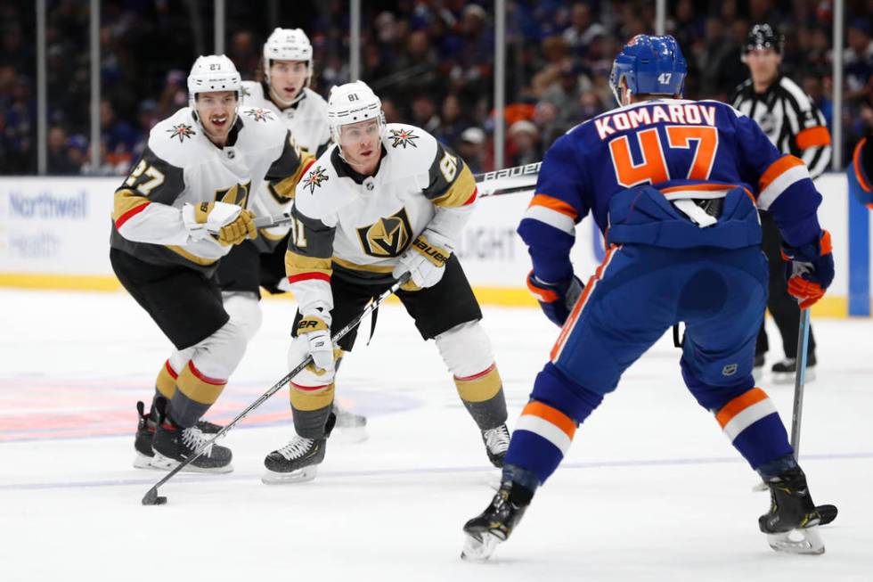 Vegas Golden Knights center Jonathan Marchessault (81) and defensemen Shea Theodore (27) and Ni ...