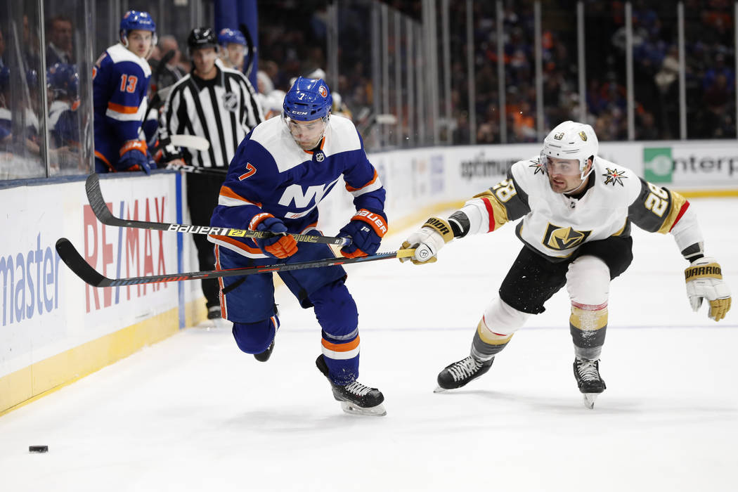 Vegas Golden Knights left wing William Carrier (28) gets his stick in front of New York Islande ...