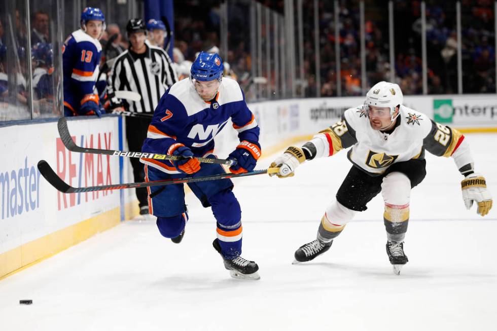 Vegas Golden Knights left wing William Carrier (28) gets his stick in front of New York Islande ...