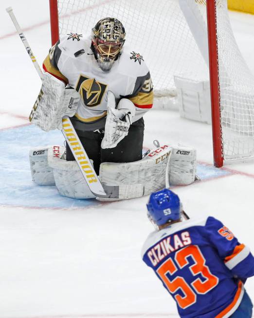 A shot by New York Islanders center Casey Cizikas (53) bounces near the chin of Vegas Golden Kn ...