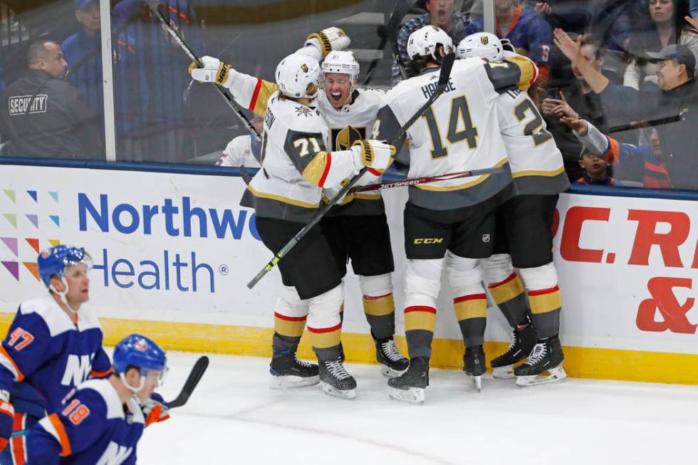 Vegas Golden Knights center Jonathan Marchessault (81) is congratulated by teammates after he s ...