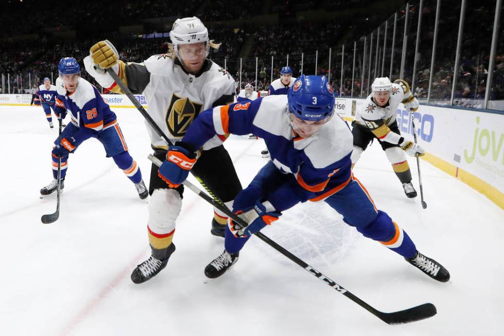 Vegas Golden Knights center William Karlsson (71) an d New York Islanders defenseman Adam Pelec ...