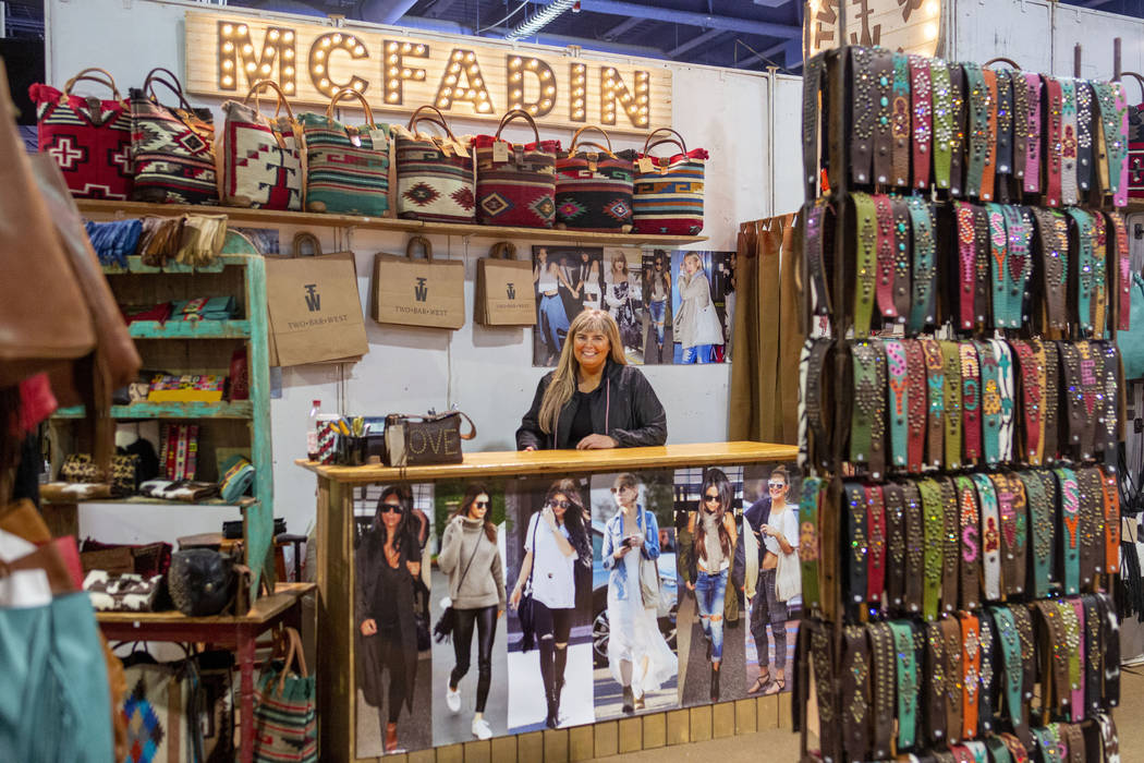 Owner of McFadin Leather Goods Laurie McFadin of Sabinal, Texas, works her booth at Cowboy Chri ...