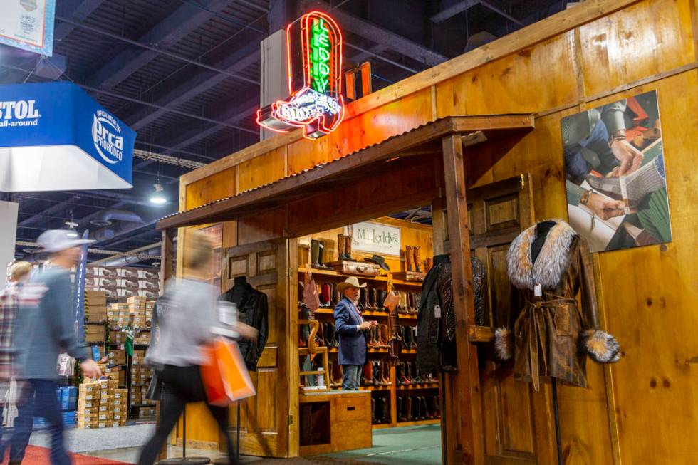 Individuals enter the M.L. Leddy's booth at Cowboy Christmas at the Las Vegas Convention Center ...
