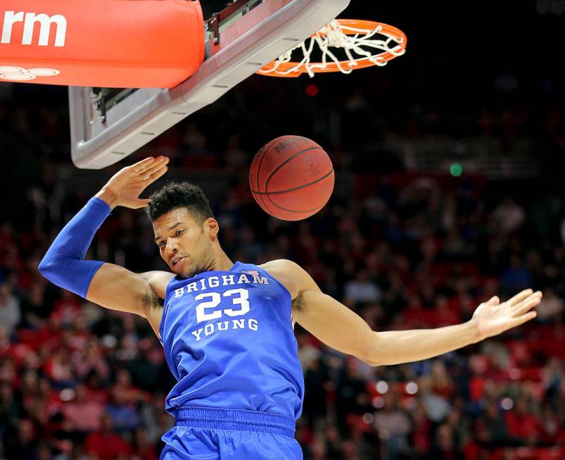 BYU forward Yoeli Childs (23) dunks against Utah during an NCAA college basketball game in Salt ...