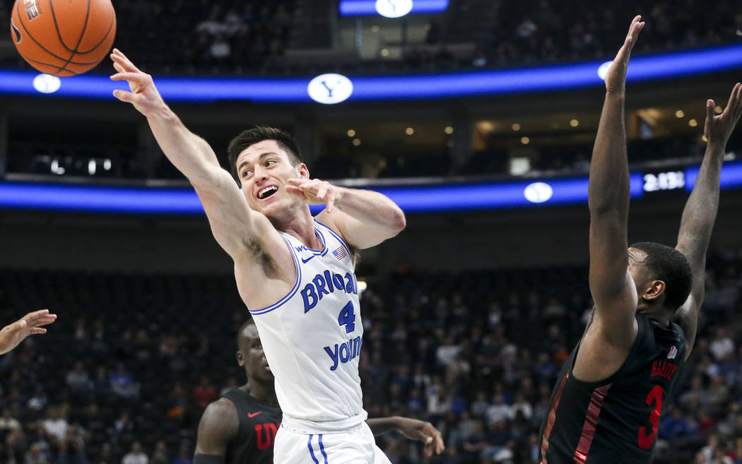 BYU guard Alex Barcello (4) passes to a teammate after being blocked on his shot by UNLV guard ...