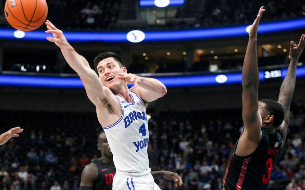 BYU guard Alex Barcello (4) passes to a teammate after being blocked on his shot by UNLV guard ...