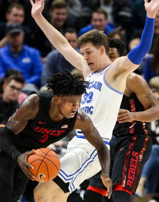 UNLV forward Donnie Tillman (2) fouls BYU forward Dalton Nixon (33) during the second half of a ...